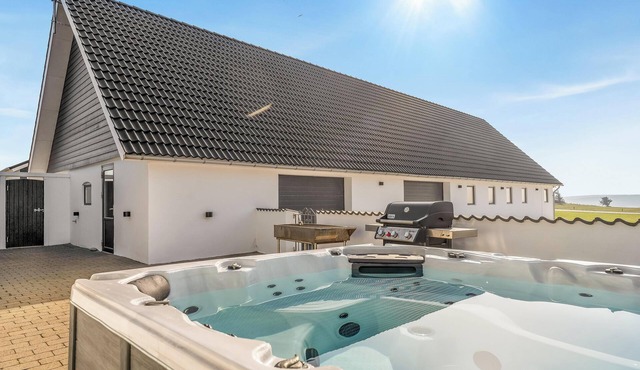 Luxury house with outdoor hot tub and activity room, and unique view of Thy.