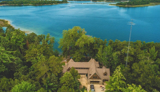 Luxury Lake Belle Taine retreat with private beach, sauna & four-season fun.