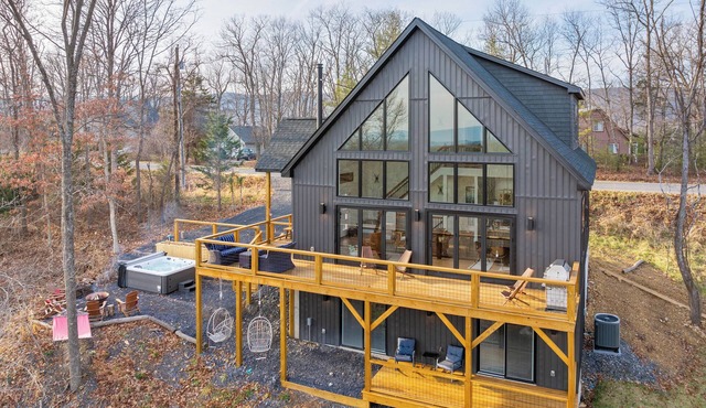 Luxury mountain cabin with year-round views, hot tub, arcade, fire pit and more.