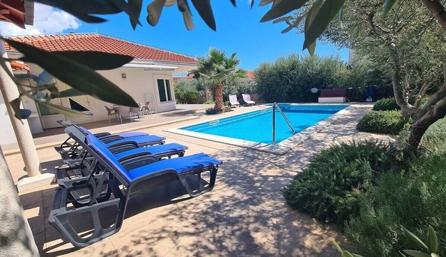 Luxury private family oasis with pool, game room and peaceful garden.