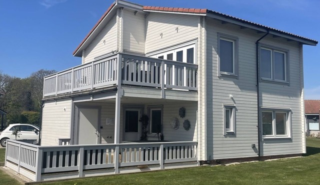 Luxury Scandinavian style lodge with own hot tub & sauna on golf resort.