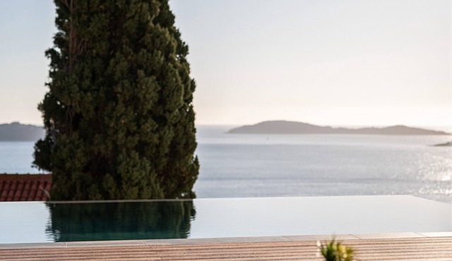 Luxury sea view villa with a heated infinity pool and a stunning sunset