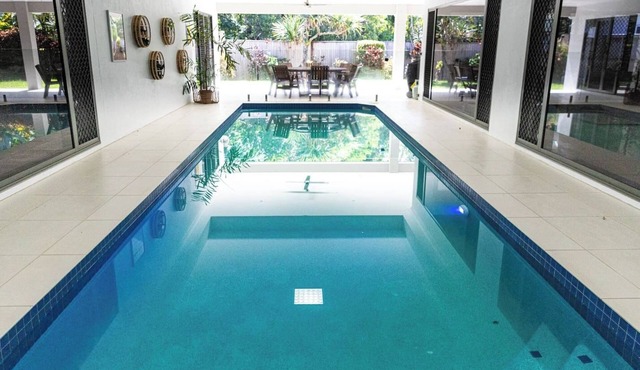 Luxury Tropical Escape: Beachside Villa with Heated Pool & Modern Comforts