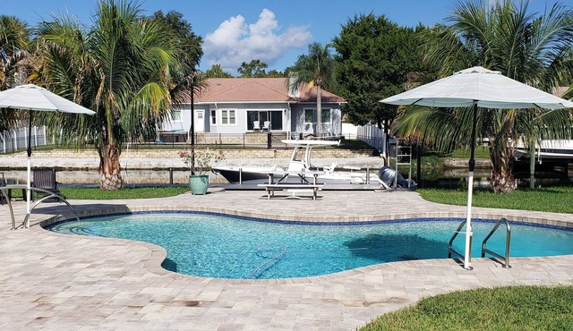 Luxury waterfront pool home with dock.