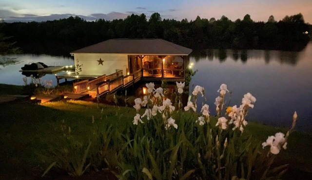 Main house & guest cottage on over 400 feet of waterfront on the public side