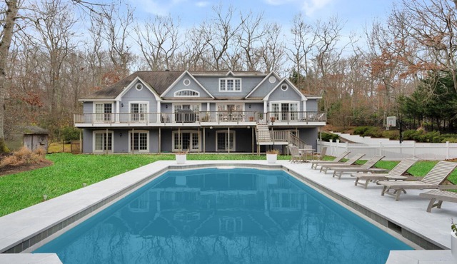 Majestic estate on over one acre of lush land, beautiful landscaping,.