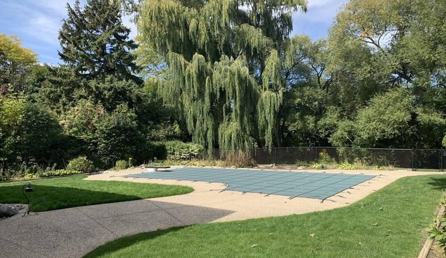 Master bedroom with picturesque view to backyard and ravine