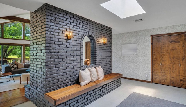 Mid-century home on seven serene acres of rolling meadows with private pool.