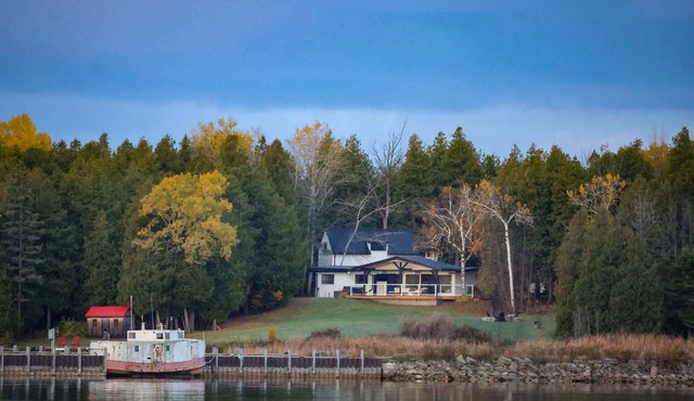 Midnight Star is a bright, modern Stokes Bay waterfront cottage with 3 bedrooms, 2 bathrooms, a private dock, sauna, hot tub, stone fireplace, open-concept living, and epic sunsets—perfect for easy Bruce Peninsula lake days.