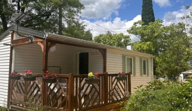 Mobile home on the banks of the Ardèche and the medieval village of Aiguèze