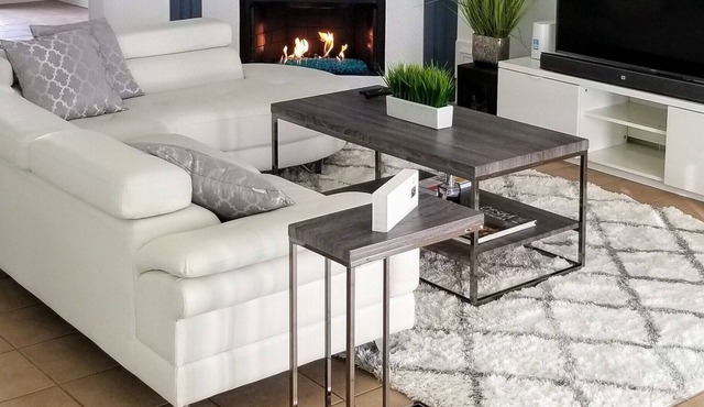 Modern 2br house with glass fireplace and patio.