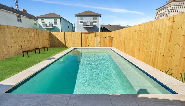 Modern 4BR Mid-City home with heated pool & balcony. Free parking, walk to streetcar & parades.