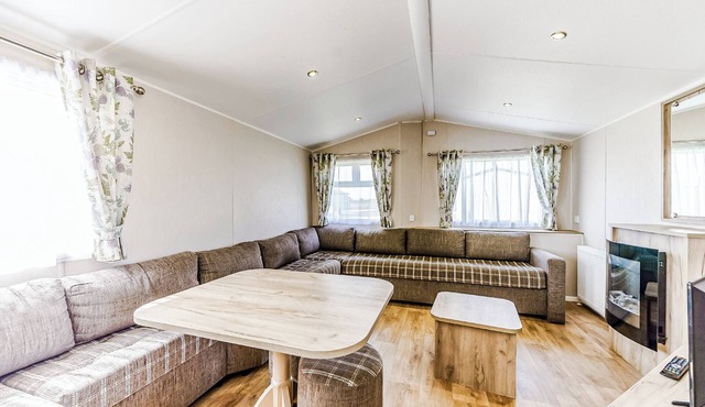 Modern and contemporary 12ft-wide caravan with one double and two twin.