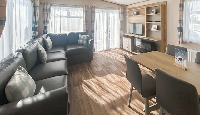 Modern and contemporary 12ft-wide caravan with one double and two twin.