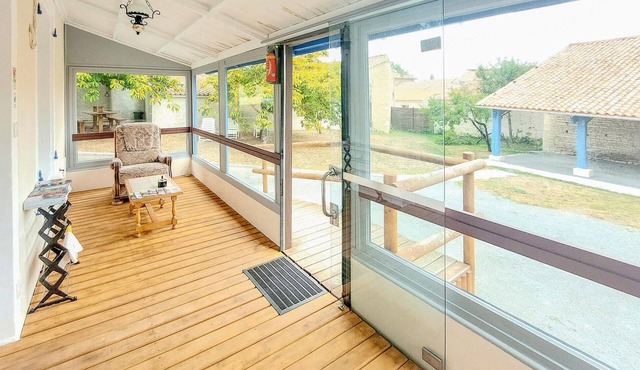 Modern cottage with glazed veranda and play area for the whole family.