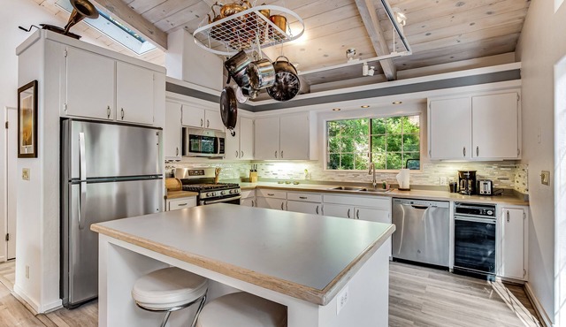 Modern, Dog-Friendly Retreat with a Private Deck, Hot Tub, Fireplace, & Sun Room