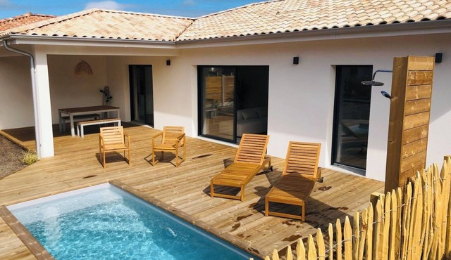 Modern house with swimming pool, between lake and forest