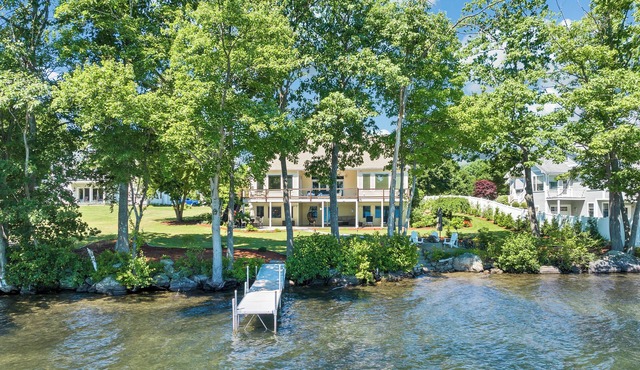 Modern Lake Opechee Home features Sandy Perched Beach and Dock