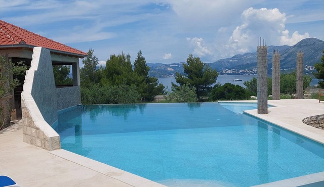Modern stone villa with infinity pool.