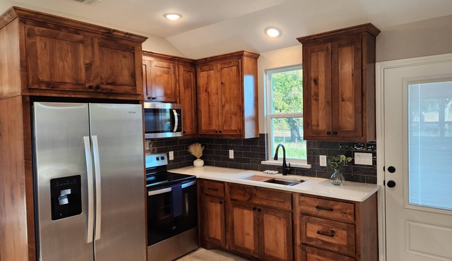 Modern-style cabin, located in rustic farmland near Bend, TX.