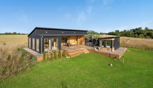 Modern, stylish cottage with bio fireplace, natural plot and views of fields.