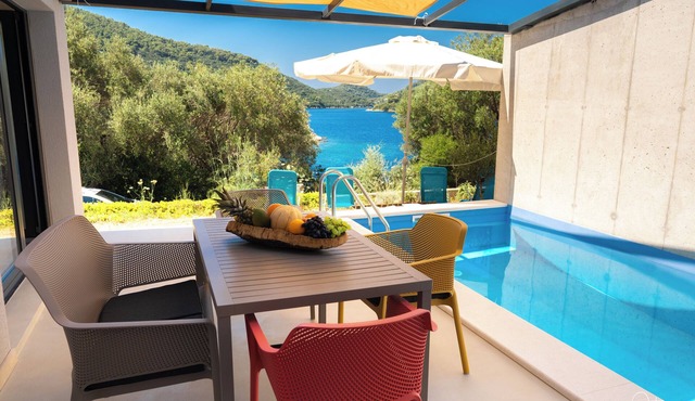Modern villa in a picturesque bay: quiet location, pool & natural intimacy