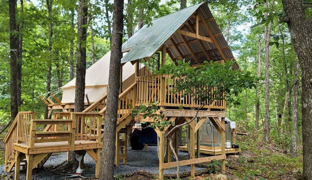 Mountain Bell tent Tree house providing views of surrounding mountains and lake.
