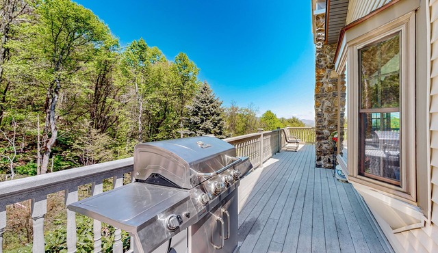 Mountain view home with a furnished deck, gas fireplace, & washer/dryer