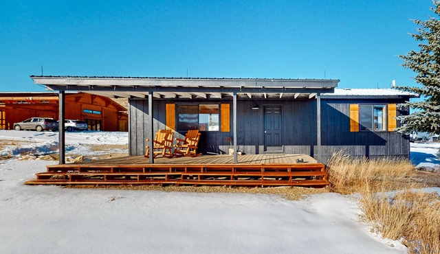 Mountain-view retreat on 1,800-acre ranch with animals, firepit, games, & deck