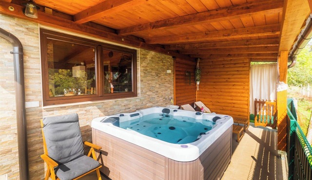 Mountain wooden retreat with jacuzzi, sauna and nature views.