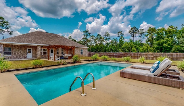 Nautical-themed retreat with a saltwater pool, fire table, full kitchen, and AC