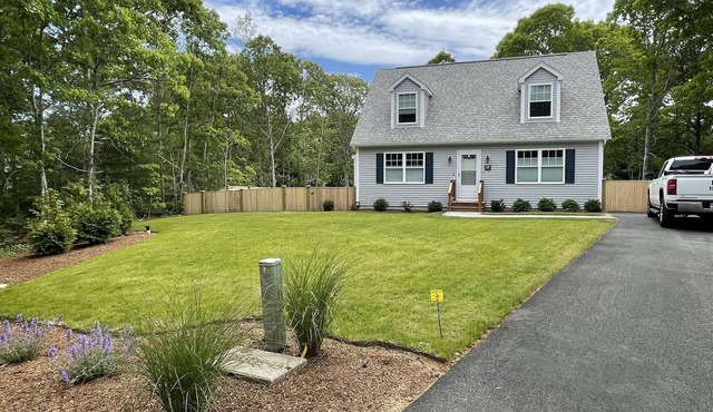 New construction cape house close to shops and 3 miles from the beach .