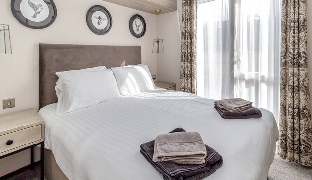 New in 2022. Lodge with two bedrooms, one double with en-suite and one twin and a shower room.