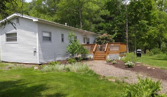 Newly renovated home on 13 acres with a beautiful pond, great for fishing!