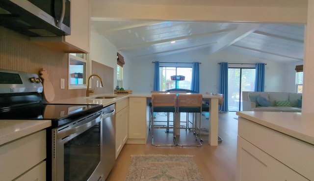 Newly renovated home with air hockey, games, huge TV wall,fenced yard+screenroom