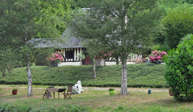 Norman house surrounded by nature with lake