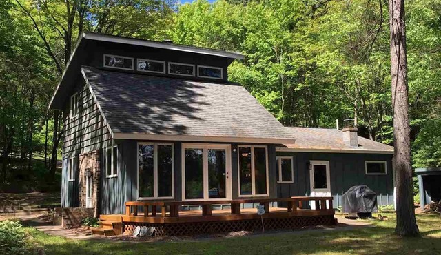 Northwoods lake home with gentle slope to clear lake with sandy beach