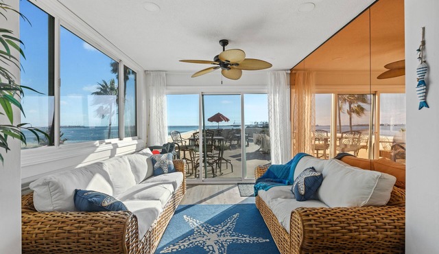 Oceanfront retreat with rooftop deck, modern interior, marble finishes, & W/D