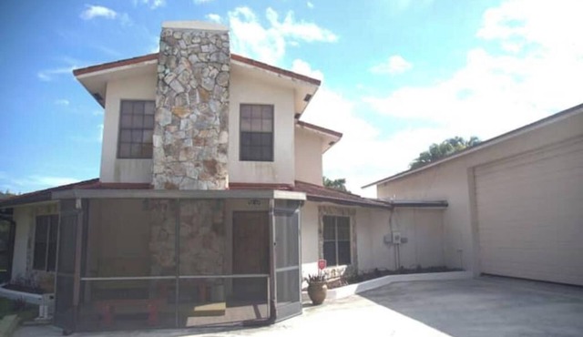 Octagonal 2-story West Palm waterfront home w/dock, boat ramp, & private parking