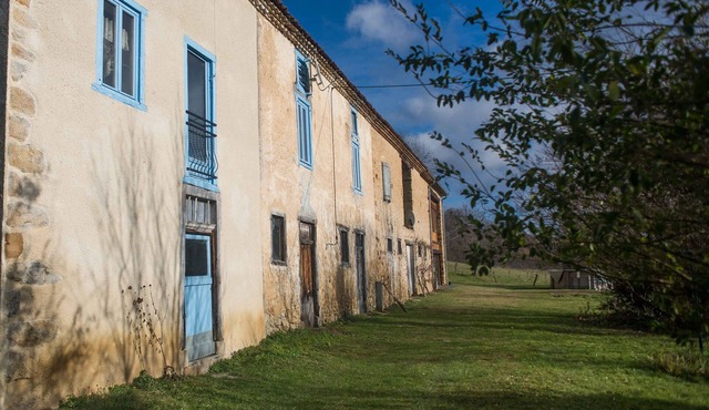 Old farmhouse in the middle of fields near a greenway