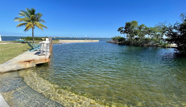 Old Florida Style, wrap around porch, boat basin for dockage, open water
