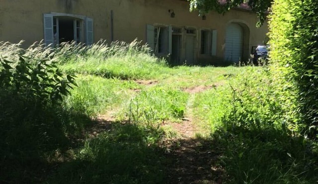 Old house on a medieval mound in the heart of a village in Val d'Amour