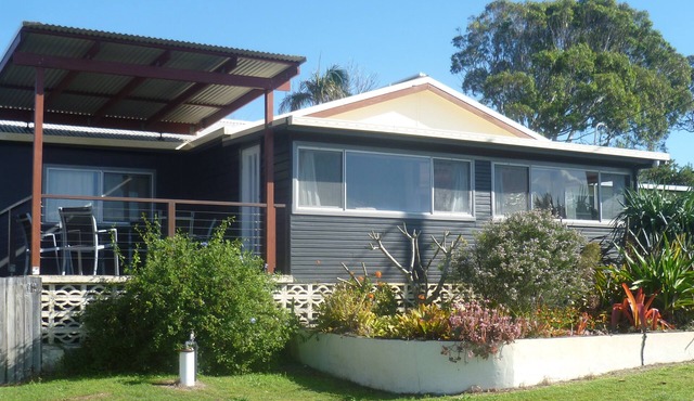 Old style beach house with views of the river joining the ocean