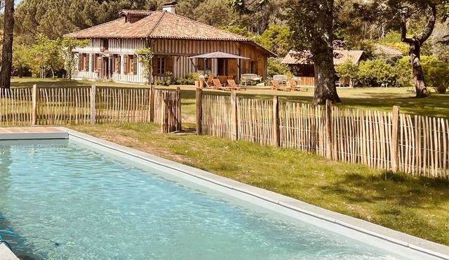 Old traditional house at the Maisons Huraia between forest, lake and ocean
