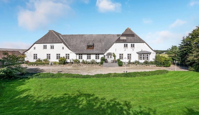 Older property in a rural setting with views of the water tower in Tønder.