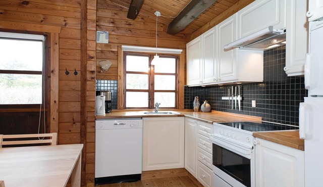 On a natural plot near the water lies this renovated log house with beautiful terrace.
