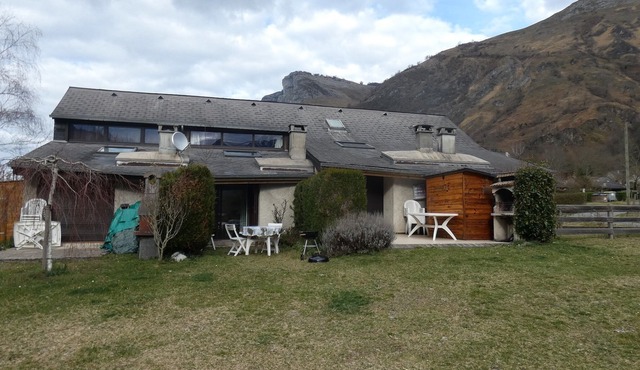 On river bank with mountain views and ground-level terrace