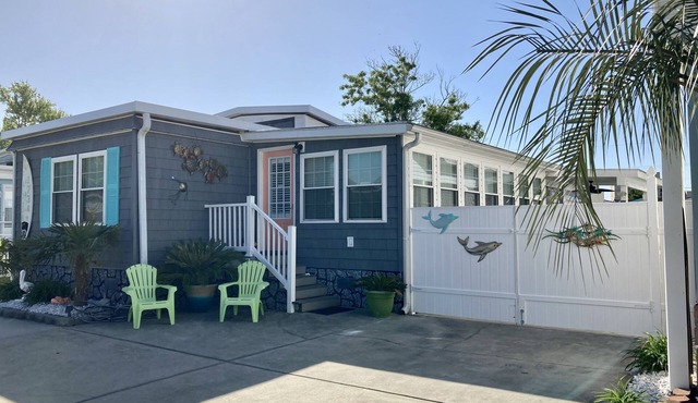 One minute drive to beach with golfcart! Updated, beach decor & clean!