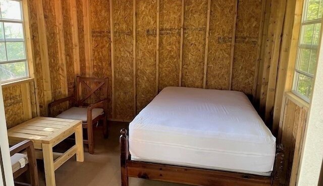 One Room Cabin with a double bed and small table with two chairs