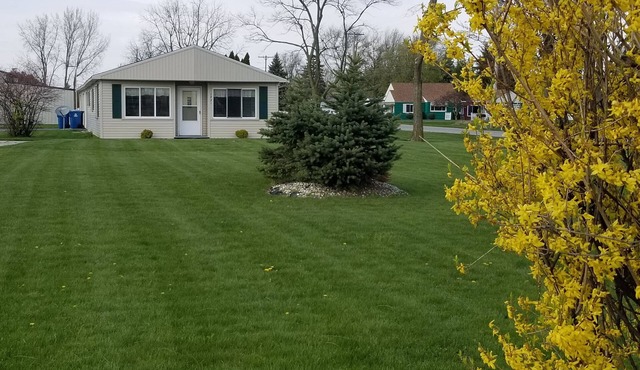 Open concept 2 bedroom ranch with attached garage and deck